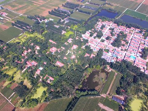 1536541070973898.jpg 4、图中左边为树木掩映下加固的老民居,右边为迁建后的新民居  董希文摄_副本.jpg